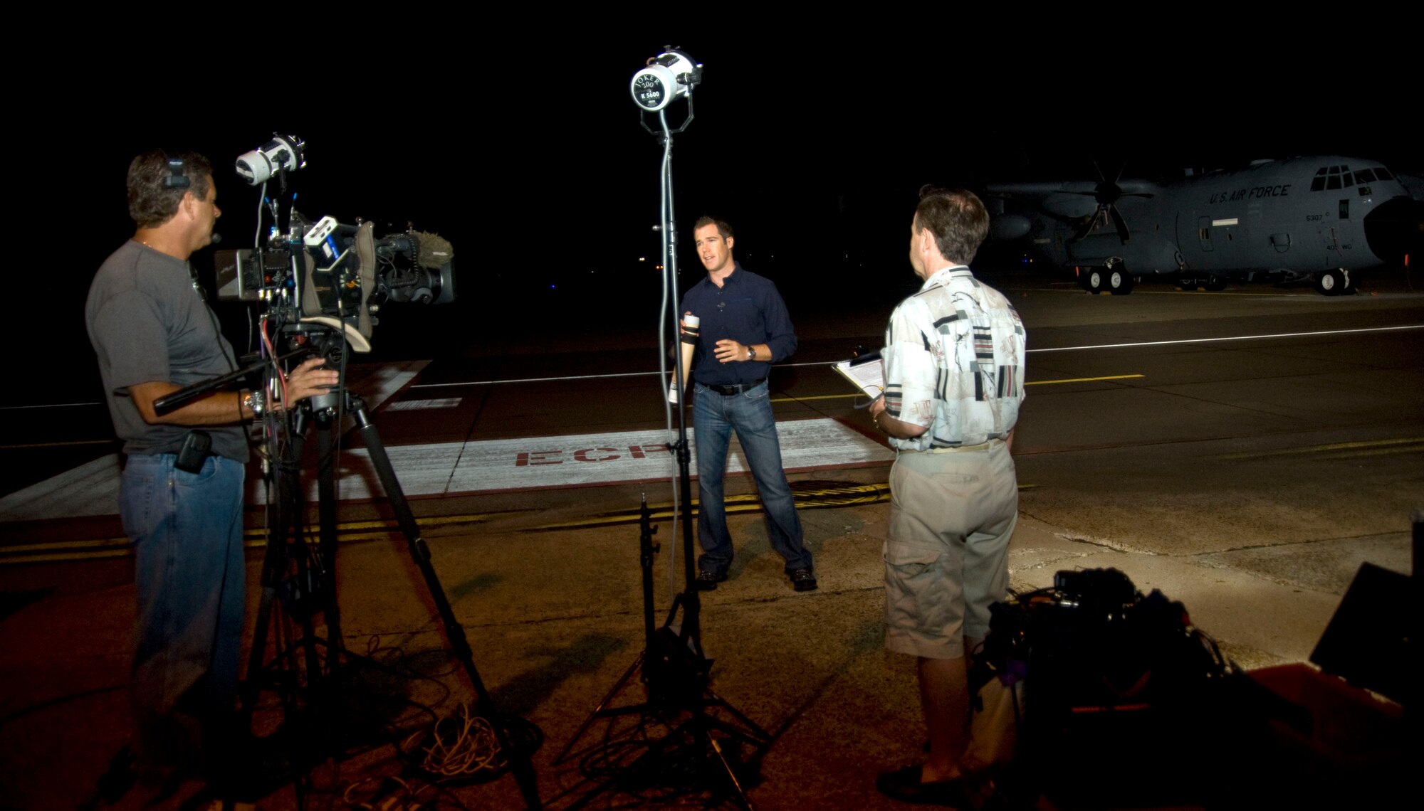 NBC news correspondent Peter Alexander prepares for his live feed to the Today Show on the morning of Aug. 25 while his cameraman and producer provide feedback. Alexander and his film crew were given the opportunity to fly with the Hurricane Hunters on a mission into the eye of Hurricane Irene Aug. 25.