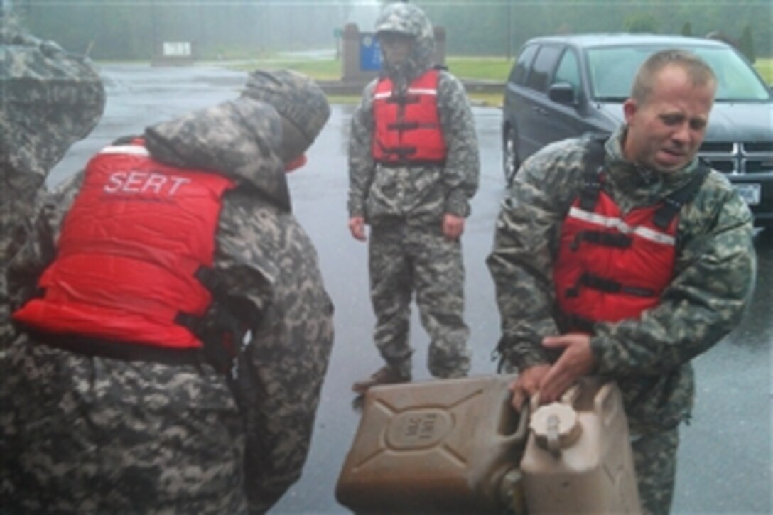 Soldiers prepare tactical vehicles for a mission as Hurricane Irene blows in North Carolina, Aug. 27, 2011. The soldiers are assigned to the 230th Brigade Support Battaltion, 30th Heavy Brigade Combat Team, North Carolina Army National Guard. 