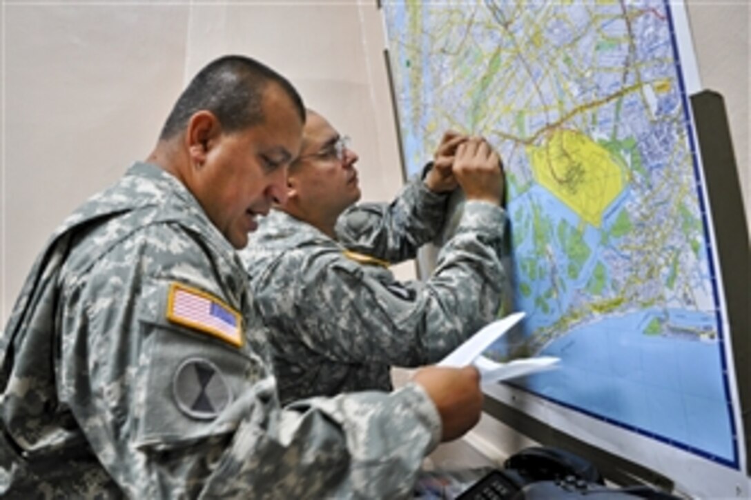 Soldiers review an area map as part of efforts by New York Gov. Andrew Cuomo to mobilize almost 2,000 New York National Guard troops to support Hurricane Irene emergency operations in New York, Aug. 27, 2011. Additional soldiers were to arrive Aug. 28.