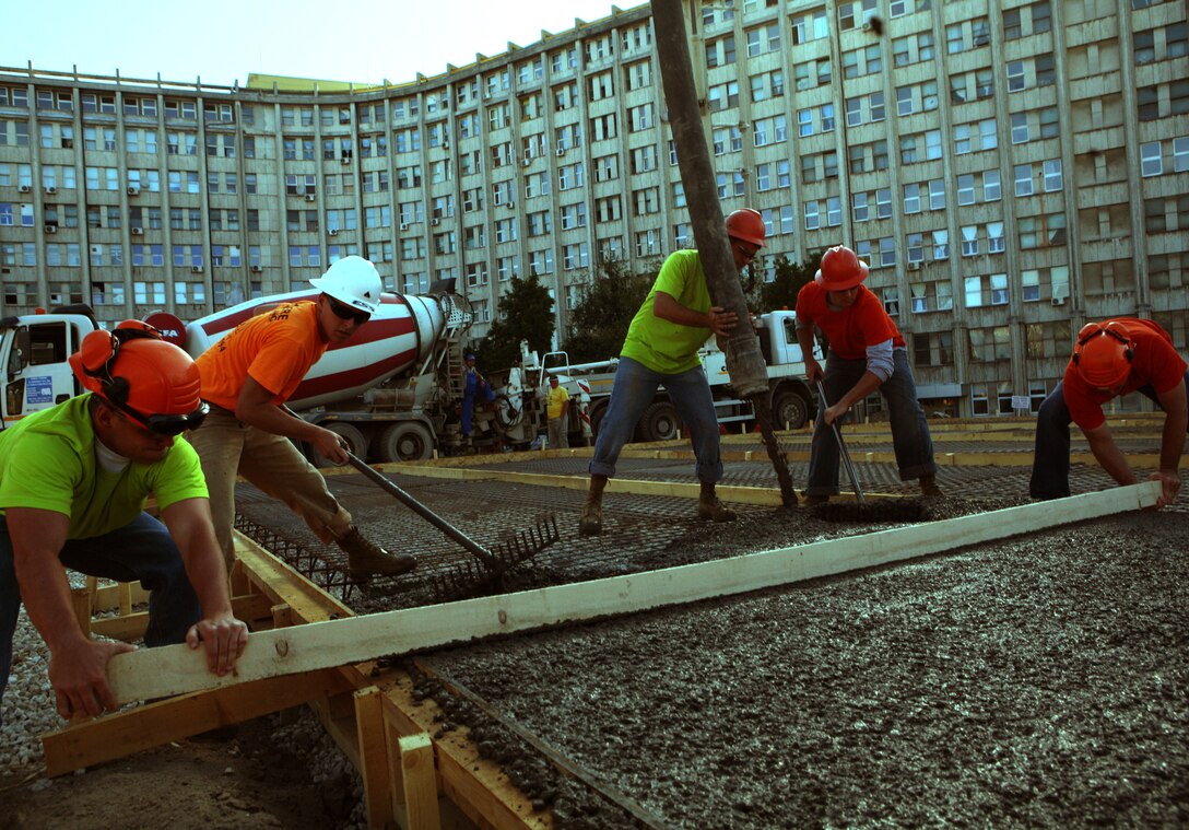 Working rapidly as a team, combat engineers with Black Sea Rotational Force 11, spread and screed the flowing concrete being poured for a new helipad for Constanta County Hospital. Combat engineers with Black Sea Rotational Force 11 contracted with Romanian excavation specialist to then buildt a helipad for Constanta County Hospital that will alleviate flight time for patients to the emergency room and will allow helicopter evacuation of critically-wounded patients to the trauma center at the hospital -- the only one within approximately 260 kilometers -- and potentially save lives. help to save more lives by getting casualties prompt and rapid medical care. The landing pad was part of the engineer’s last community relations project for the country before they are slated to depart back to the states this month.  Marines and their hometowns from left to right; Lance Cpl. Josh Dufrane, Chicopee, Mass., Cpl. Kyle A. Dugas, Plainfield, Conn., Lance Cpl. Angelo Moriello, Naugatuck., Conn.,  Cpl. Joshua M. DeWitt, Lake Orion, Mich., and Cpl. John F. Fitzpatrick, Medford, Mass.::r::::n::