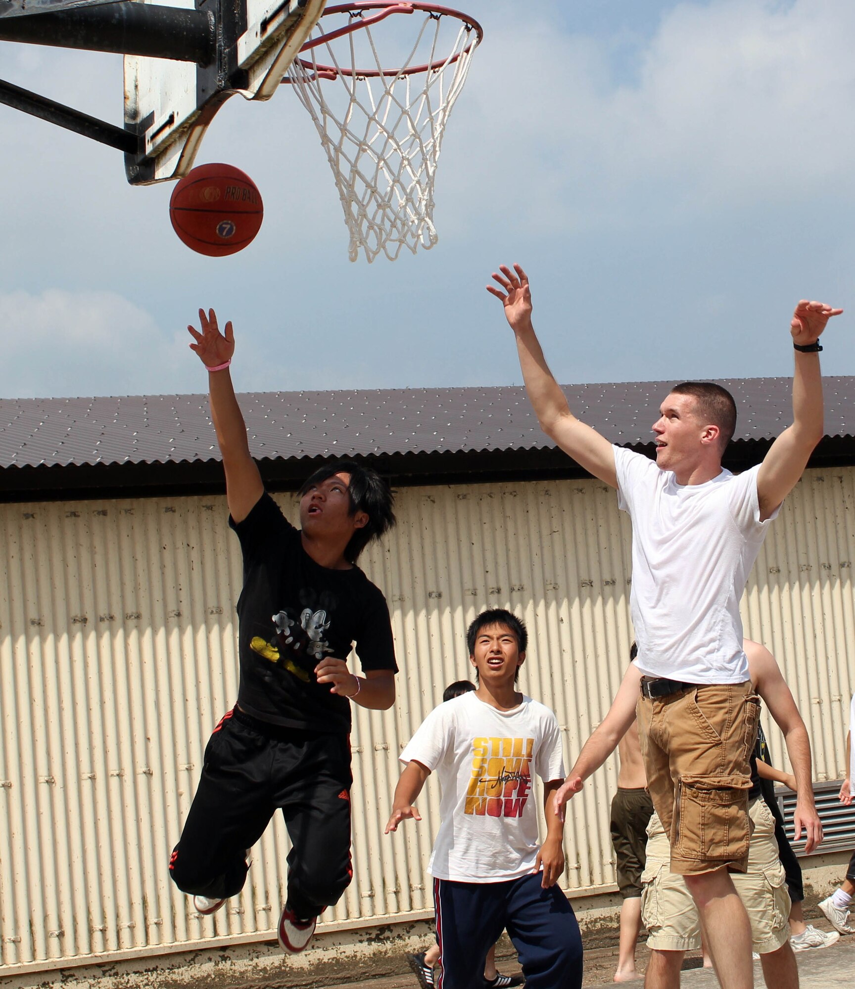 MISAWA AIR BASE, Japan – Members of the 35th Logistics Readiness Squadron play basketball here with children from the Fuji Sei Boen Children’s Home in Aomori City during an annual visit Aug. 20. The school and members of Misawa Air Base have shared partnership for 30 years. (Courtesy photo)