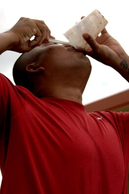 Jose Hilliard, a Team Andersen dependant, downs a concoction of canned escargot, shrimp paste, fish sauce and various assortments of other delicacies during the second round of Andersen’s Annual Fear Factor challenge. More than 20 competitors participated in the challenge for a grand prize of two $200 Delta Airlines travel vouchers. In the end, Jacob Greathouse, a Team Andersen dependant, was able to clench victory and the grand prize for the second consecutive year. (U.S. Air Force photo/Senior Airman Carlin Leslie) 

