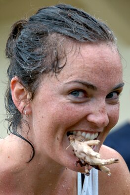 Nellie Boyer, a Team Andersen dependant, chomps down on a chicken’s foot, and ultimatelywon second place during Andersen’s Annual Fear Factor challenge. More than 20 competitors participated in the challenge for a grand prize of two $200 Delta Airlines travel vouchers. In the end, Jacob Greathouse, a Team Andersen dependant, was able to clench victory and the grand prize for the second consecutive year. (U.S. Air Force photo/Senior Airman Carlin Leslie) 


