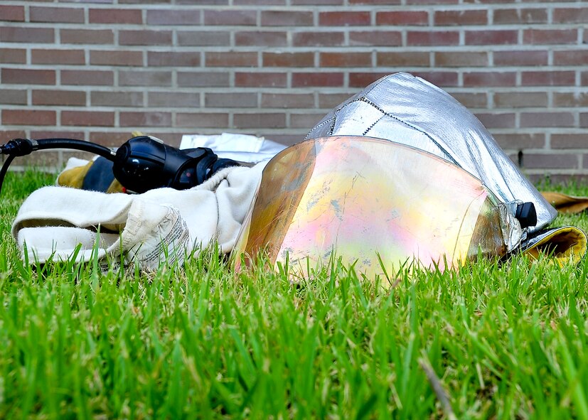 Find the fire, fight the fire and perform primary searches for victims are a few of the National Fire Protection standards Airmen from the 51st Civil Engineer Squadron were evaluated on during exercise Beverly-Midnight 11-04, Aug. 29, 2011. Once extinguished the Airmen downgraded their gear and proceeded to return to their fire station. (U.S. Air Force photo/Senior Airman Adam Grant)