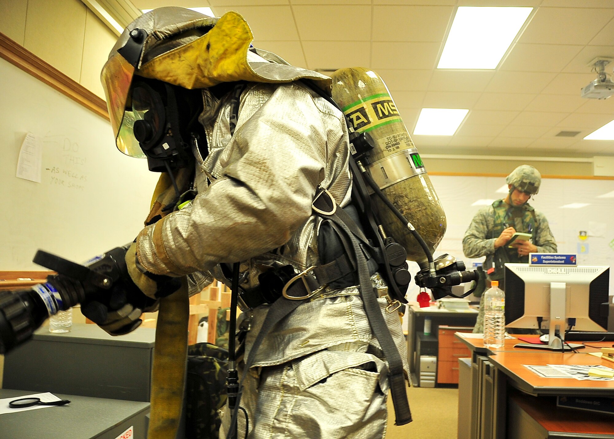 An Airmen from the 51st Civil Engineer Squadron, locates a sign of smoke during primary checks Aug. 29 2011 during exercise Beverly-Midnight 11-04. Once the fire is located and extinguished the Airmen from the 51st CES will then search for victims and once deemed safe depart the premises.  (U.S. Air Force photo/Senior Airman Adam Grant)