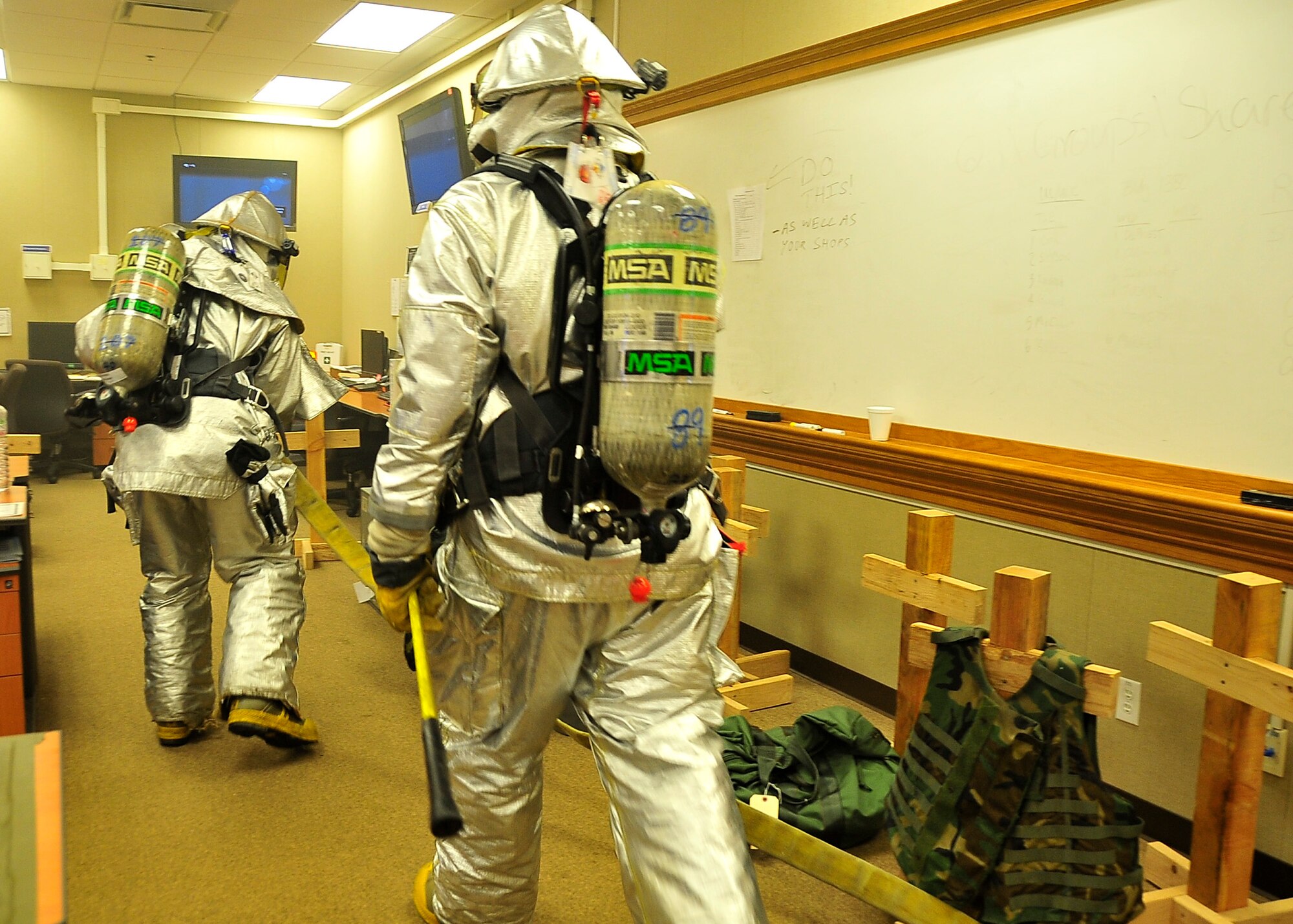 Airmen from the 51st Civil Engineer Squadron, perform primary searches for victims Aug. 29, 2011 during exercise Beverly-Midnight 11-04. During the exercise Airmen were evaluated on their timeliness to the scene as well as their ability to follow the National Fire Protection standards which are find the fire, fight the fire, do primary search for victims and once the fire is eliminated exit the scene.  (U.S. Air Force photo/Senior Airman Adam Grant)