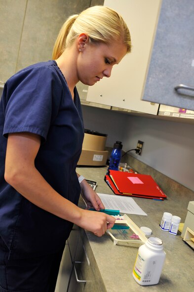 Megan Weddle, a veterinary technician, counts antibiotics for a patient in the veterinary clinic on Barksdale Air Force Base, La., Aug. 29. The clinic administers vaccinations and performs routine surgical procedures for pets of Barksdale Airmen and their families. (U.S. Air Force photo/Senior Airman Chad Warren)(RELEASED)