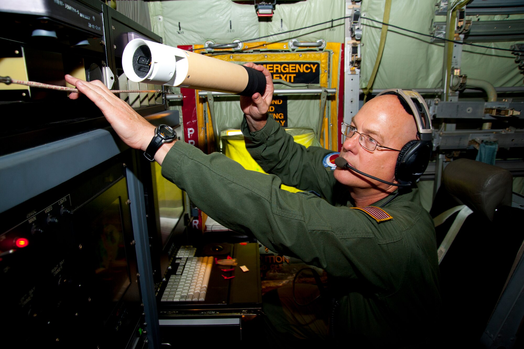 Senior Master Sgt. Anthony Hlavac, 53rd Weather Reconnaissance Squadron loadmaster, stores a dropsonde he prepared for release into Hurricane Irene August 27. The dropsonde is a parachute-borne device that measures and encodes storm data as it drops toward the surface of the water. It measures air temperature, relative humidity, barometric pressure, and wind speed and direction. (U.S. Air Force photo/Tech. Sgt. Ryan Labadens)