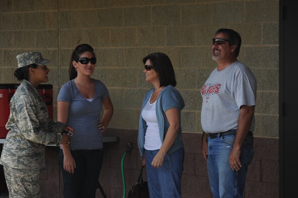 U.S. Air Force 2nd Lt. Cara Bousie talks with attendees of a Valdosta State University scrimmage football game Aug. 26, 2011. The VSU scrimmage was held for Service members and their families. Future practices will also be open for military. (U.S. Air Force photo by Airman 1st Class Paul Francis/Released)