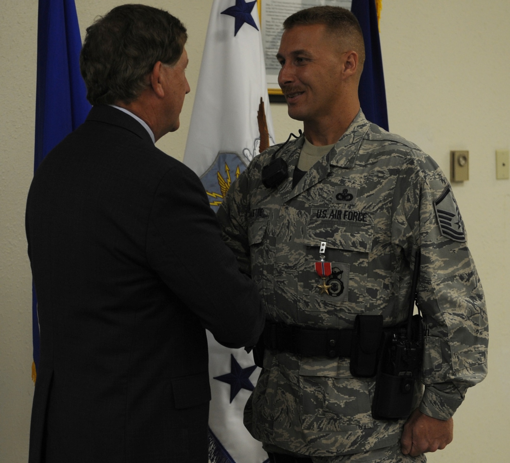 Master Sgt. Todd Duquette, 7th Security Forces Squadron flight chief, shakes hands with Terry Yonkers, Assistant Secretary of the Air Force for Installations, Environment and Logistics, after being presented the Bronze Star Medal Aug. 2, 2011 at an award ceremony at Dyess Air Force Base. Duquette distinguished himself with exceptionally meritorious service and performance as the NCO in-charge of the Police Training Assistance Team while assigned to the Laghman Provincial Reconstruction Team, Afghanistan, in support of Operation Enduring Freedom from October 2008 through July 2009. (U.S. Air Force photo by Airman 1st Class Jonathan Stefanko/ Released)