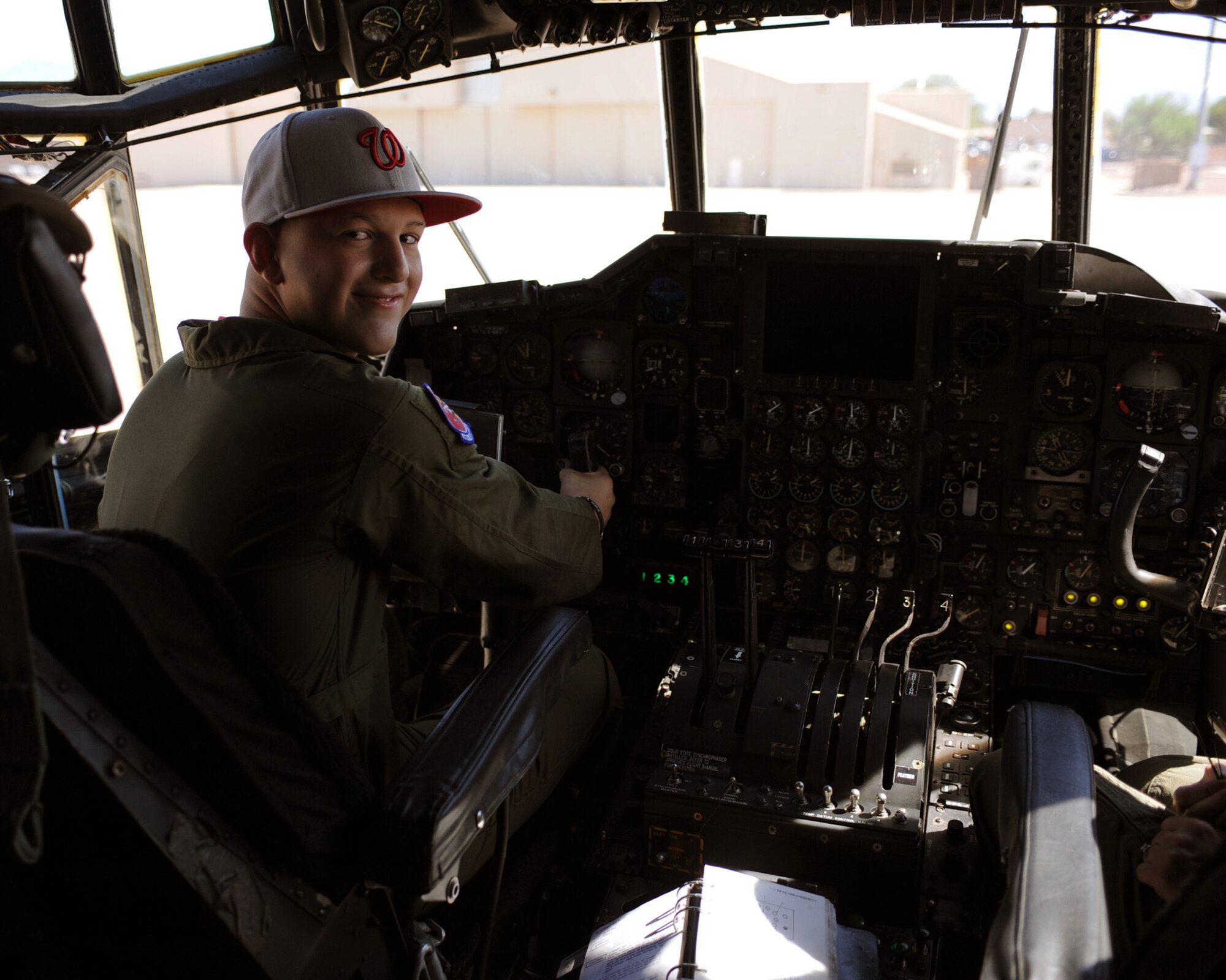 DAVIS-MONTHAN AIR FORCE BASE, Ariz. - Brandon Villes, 15, sits in a C-130 cockpit here Aug. 26. (U.S. Air Force photo/Airman 1st Class Christine Halan)