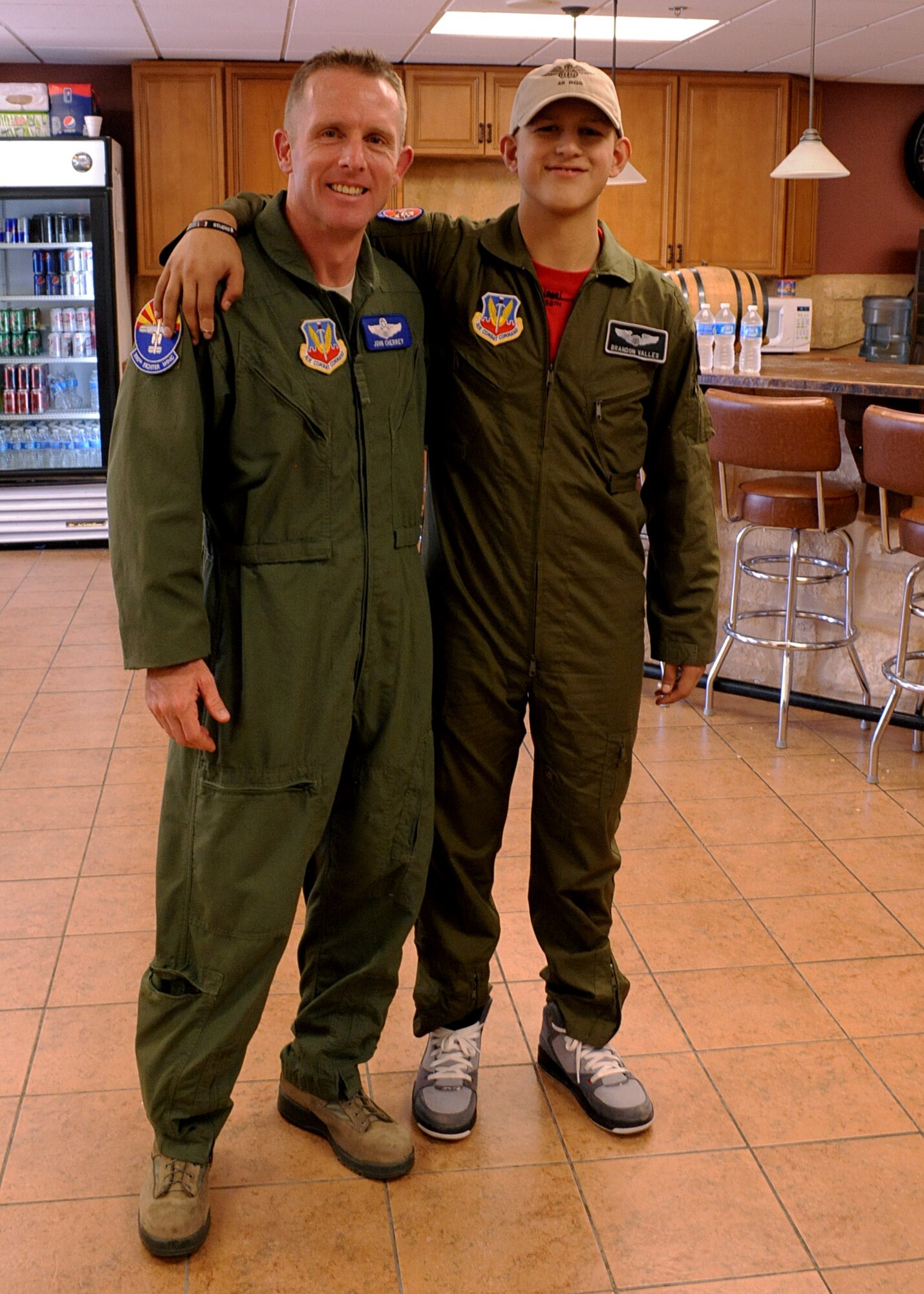 DAVIS-MONTHAN AIR FORCE BASE, Ariz. – Col. John Cherrey, 355th Fighter Wing commander, and Brandon Valles, Pilot for a Day program participant, pose for a picture here Aug. 26. (U.S. Air Force photo/Airman 1st Class Christine Halan)