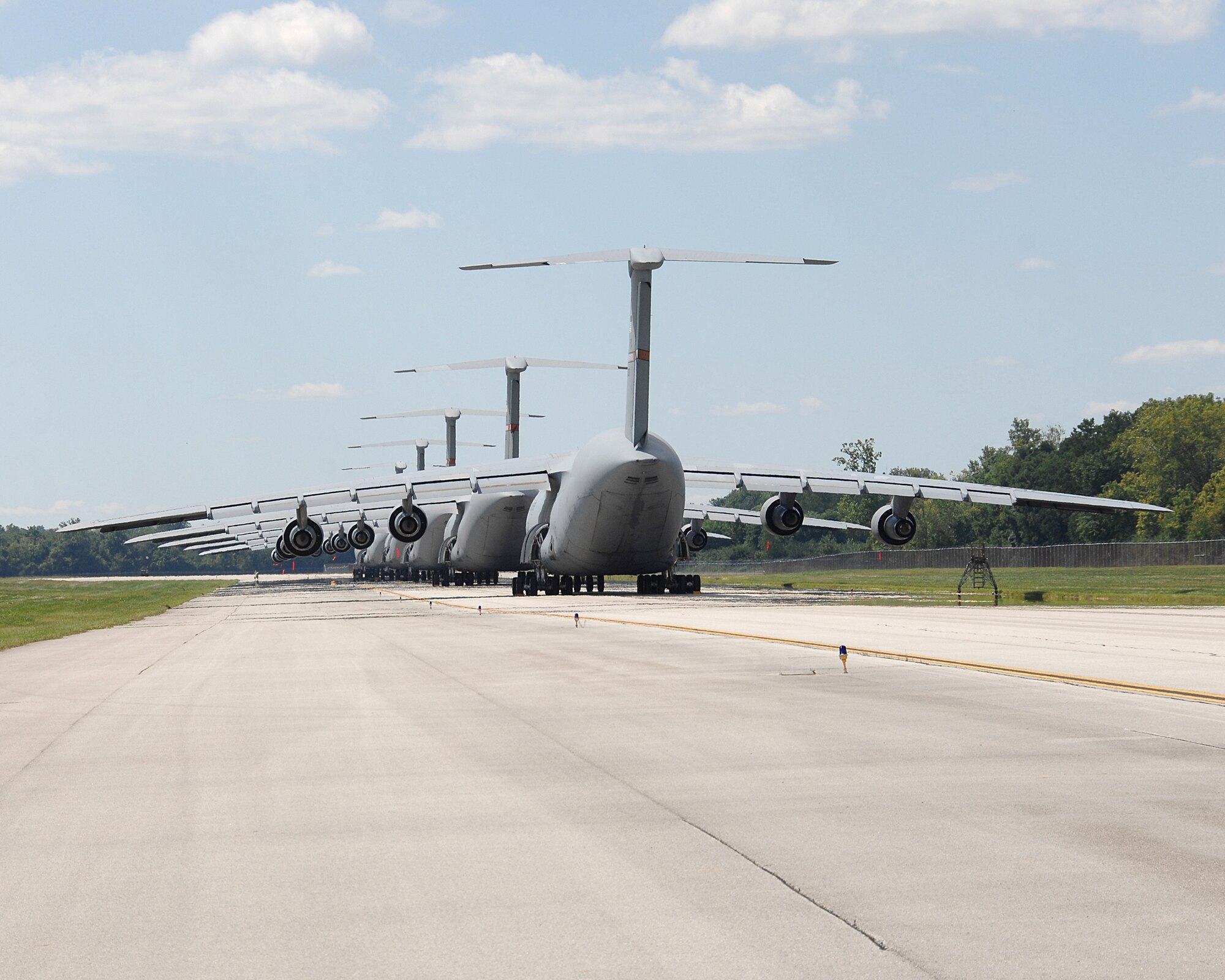 Five C-5 Galaxys sit end to end on the Wright-Patterson taxiway.  (US Air Force photo by Ben Strasser)     