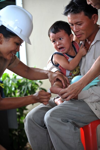 U.S. Air Force Reserve Capt. Janet Baxa, registered nurse with the 624th Aeromedical Staging Squadron, Joint Base Pearl Harbor-Hickam, Hawaii, provides medical attention to a Vietnamese boy at Thach Mon medical clinic in Ha Tinh Province, Vietnam, on Aug. 19, 2011, in support of Engineering Civic Action Program (ENCAP) Pacific Unity 2011.  The ENCAP, led by 13th Air Force, includes more than 60 U.S. and Vietnamese service members, contractors and support personnel, and helps cultivate common bonds, foster goodwill and improve relationships between the United States and Vietnam.  (U.S. Air Force image/Master Sgt. John Herrick) 