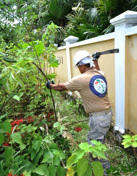 U.S. Air Force Reserve Tech. Sgt. Elmer Domingo, member of the 624th Civil Engineer Squadron, Joint Base Pearl Harbor-Hickam, Hawaii, clears brush in the garden at Thach Dong medical clinic in Ha Tinh Province, Vietnam, on Aug. 19, 2011, in support of Engineering Civic Action Program (ENCAP) Pacific Unity 2011.  The operation, led by 13th Air Force, includes more than 60 U.S. and Vietnamese service members, contractors and support personnel, and helps cultivate common bonds, foster goodwill and improve relationships between the United States and Vietnam.  (U.S. Air Force image/Master Sgt. John Herrick)