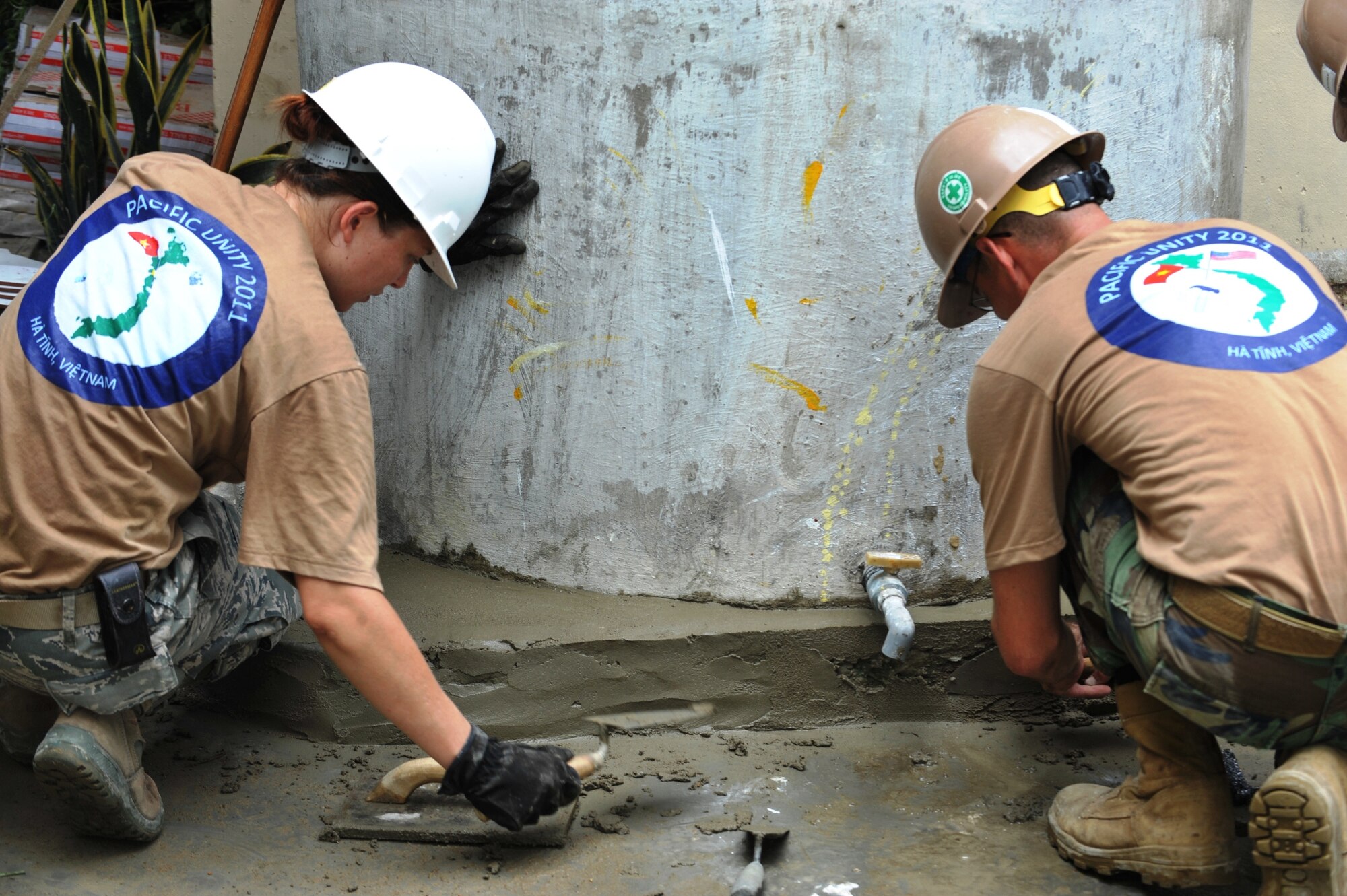 In support of Engineering Civic Action Program (ENCAP) Pacific Unity 2011, a U.S. Air Force Reserve member, from the 624th Civil Engineer Squadron, Joint Base Pearl Harbor-Hickam, Hawaii, and a U.S. Navy Seabee from Naval Mobile Construction Battalion 133, Gulfport, Miss., make improvements to a Vietnamese medical clinic in Ha Tinh Province, Vietnam, on Aug. 17, 2011.  The operation, led by 13th Air Force, includes more than 60 U.S. and Vietnamese service members, contractors and support personnel, and helps cultivate common bonds, foster goodwill and improve relationships between the United States and Vietnam.  (U.S. Air Force image/Master Sgt. John Herrick)