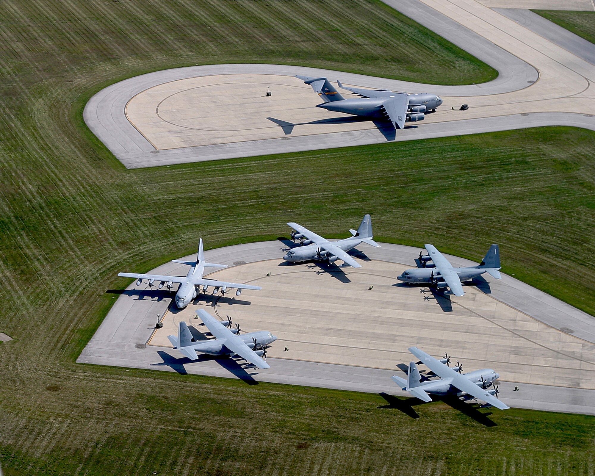 Five C-130s and one C-17 find temporary refuge at Wright-Patterson Aug. 27 and 28.  More than thirty aircraft from bases across the eastern seaboard flew here to avoid the wrath of Hurricane Irene.  An inland location and plenty of parking space makes the base an ideal location to protect Department of Defense assets.  (US Air Force photo by Ben Strasser)