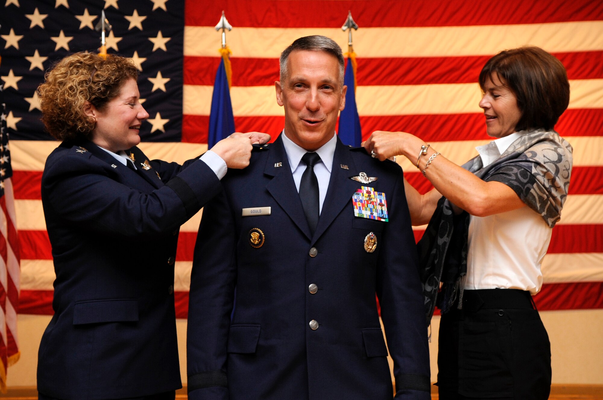 VANDENBERG AIR FORCE BASE, Calif. – Lt. Gen. Susan J. Helms, the 14th Air Force and Joint Functional Component Command for Space commander, and Stephania Gould, pin the brigadier general star to the epaulettes of Brig. Gen. Thomas F. Gould, the 14th AF vice commander, during his promotion ceremony at the Pacific Coast Club here Friday, Aug. 26, 2011. (U.S. Air Force photo/Senior Airman Lael Huss)