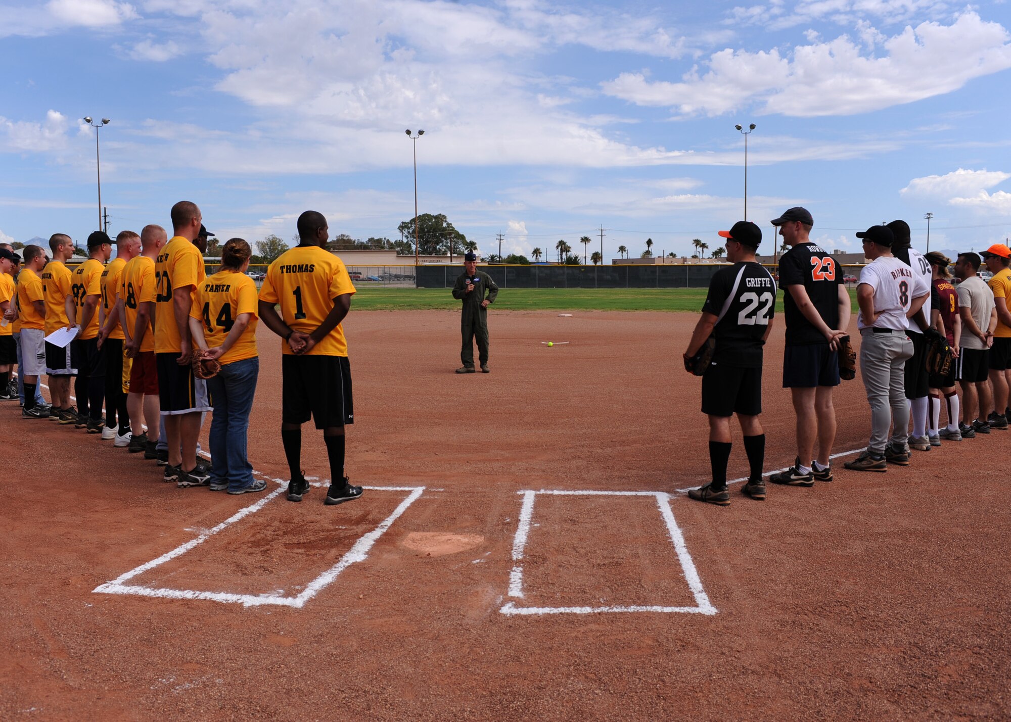 DAVIS-MONTHAN AIR FORCE BASE, Ariz. – Both the Company Grade Officer Council and the Desert Lightning 1st Six Council softball teams listen to Col. John Cherrey, 355th Fighter Wing commander, speak here Aug. 25.  The CGOC defeated the 1st Six, 18-16. (U.S. Air Force photo/ Airman 1st Class Christine Halan) 