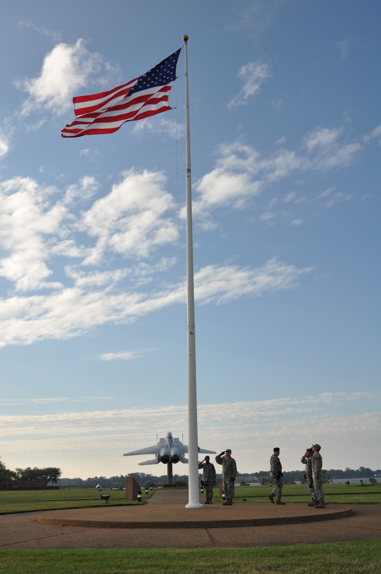 Airmen from the 633rd Security Forces Squadron and 633rd Civil Engineer Squadron raise and salute the installation colors at Langley Air Force Base, Va., following Hurricane Irene Aug. 28, 2011. Joint Base Langley-Eustis personnel began assessment and base recovery options in the early morning hours following the passing of the storm. (U.S. Air Force photo by Senior Airman Jason Joel Brown/RELEASED)