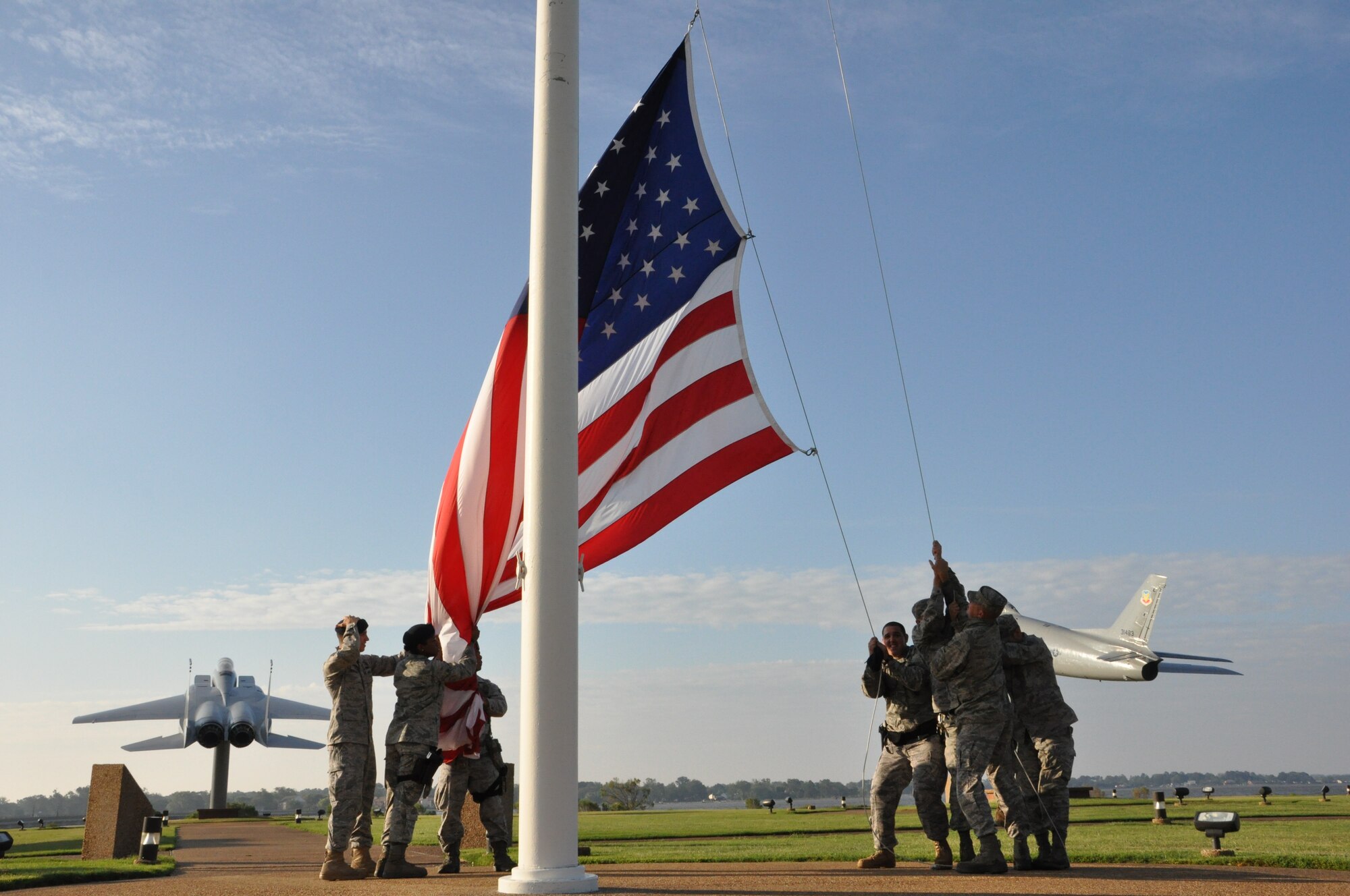Airmen from the 633rd Security Forces Squadron and 633rd Civil Engineer Squadron prepare to raise the installation colors following Hurricane Irene Aug. 28, 2011. Joint Base Langley-Eustis personnel began assessment and base recovery options in the early morning hours following the passing of the storm. (U.S. Air Force photo by Senior Airman Jason Joel Brown/RELEASED)