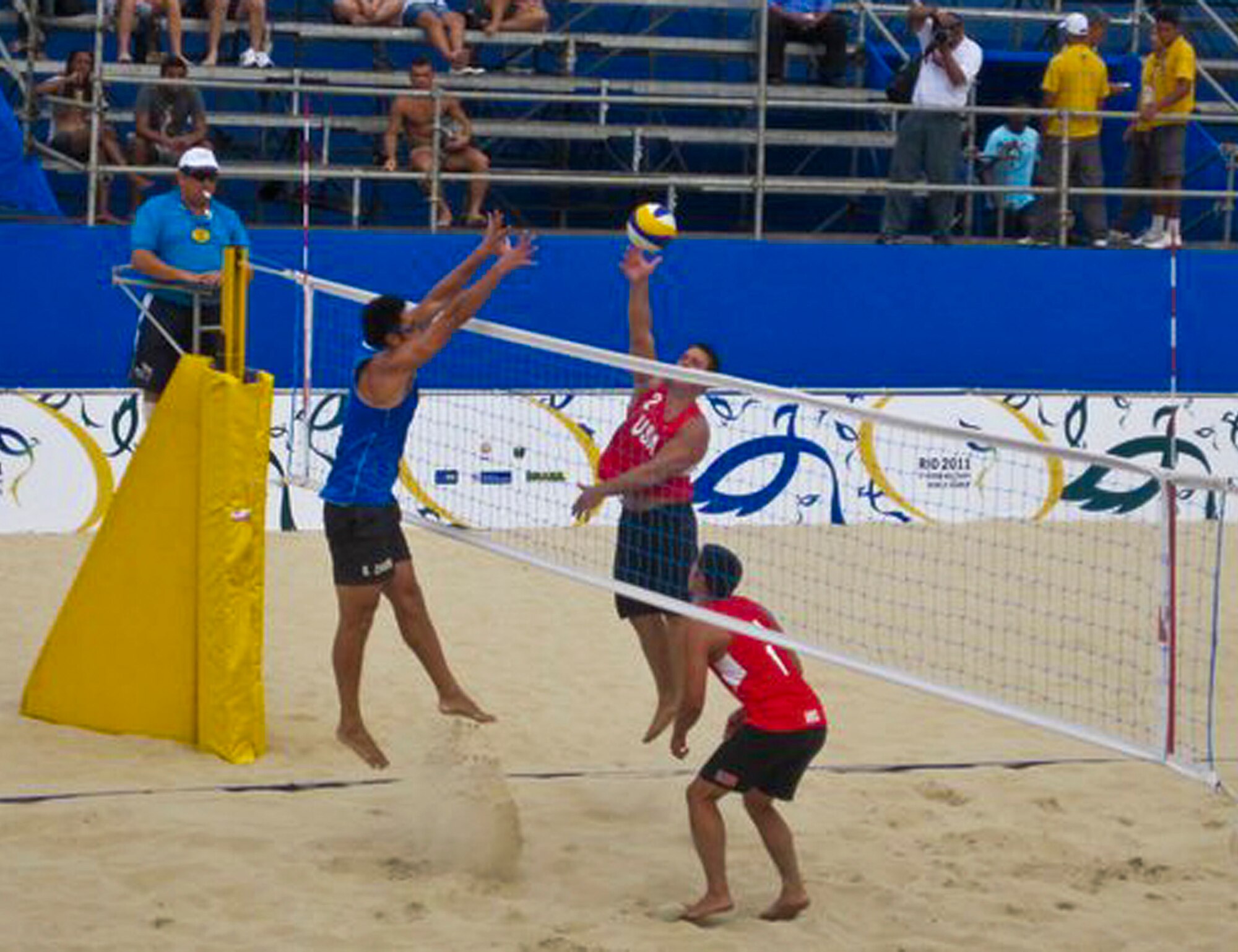 Tech. Sgt. David Dean, goes up for a spike against China's beach volleyball team during the Conseil International Du Sport Militaire 2011 World Games in Brazil.  Dean, a reserve maintainer with the 919th Special Operations Wing, was one of four military members to represent the U.S. in the beach volleyball competition at the games.  (Courtesy photo)
