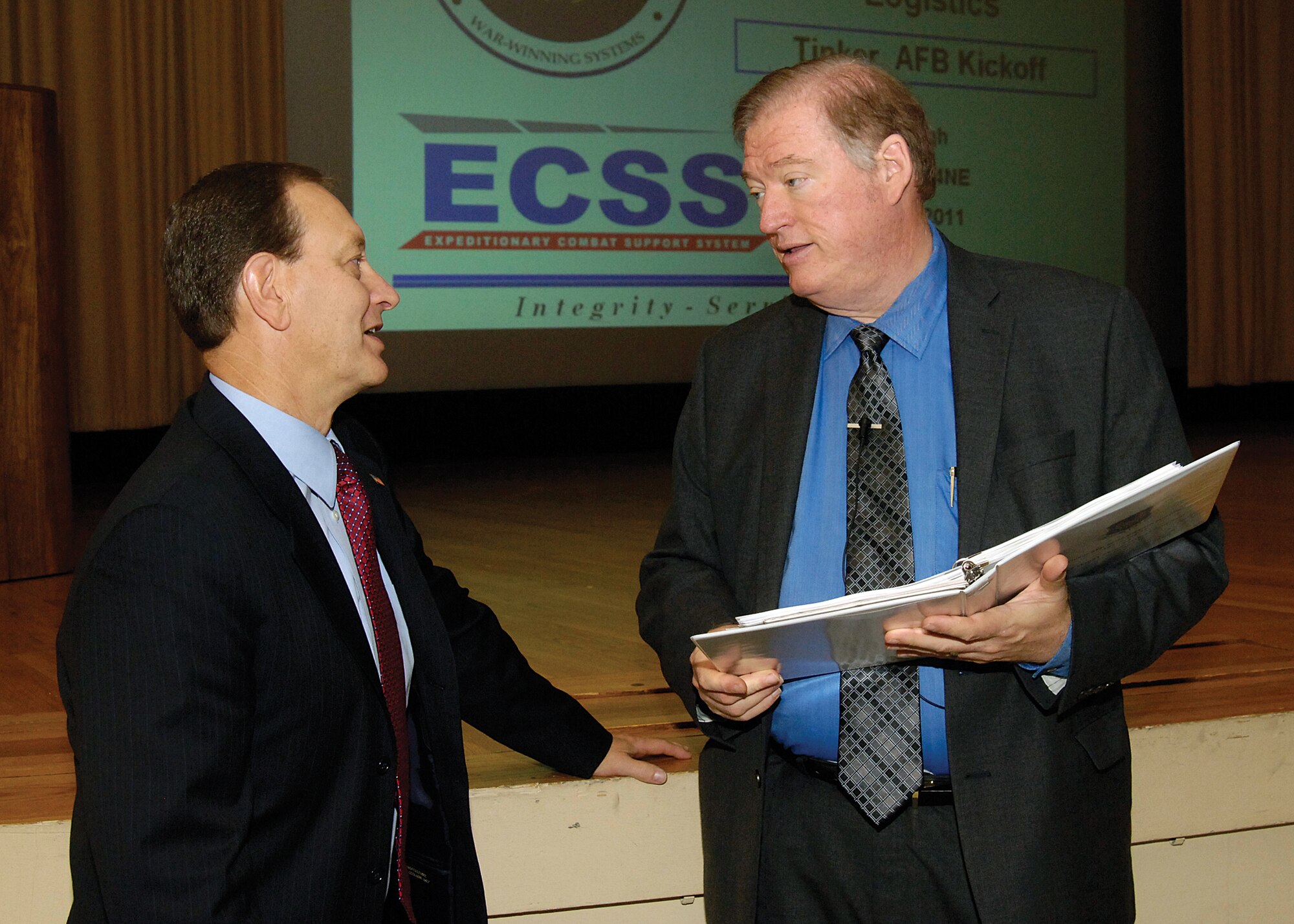 Oklahoma City Air Logistics Center Executive Director, Ross Marshall, left, welcomes Don Pugh at the start of the Aug. 17 Expeditionary Combat Support System kickoff for employees in the base theater.  Mr. Pugh, from Air Force Materiel Command Headquarters, outlined the new logistics system that is in its infancy at smaller bases but will be fielded at Tinker in 2013. (Air Force photo by Margo Wright)