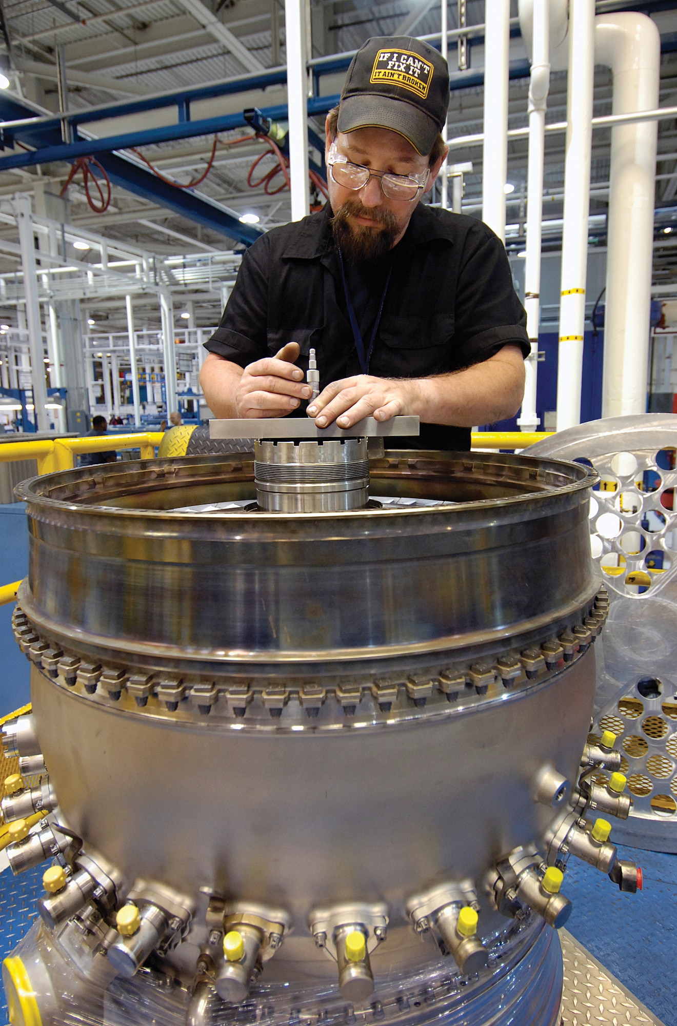 Tinker jet engine mechanic Bill Watson measures tolerances on an F100-229 high pressure turbine shaft in the Bldg. 3001 Core Assembly Shop.  The 848th Supply Chain Management Group, Oklahoma City Air Logistics Center Aerospace Sustainment Directorate and the 76th Propulsion Maintenance Group worked as a team to increase the number of ready engines from two to 41 in less than two years. (Air Force photo by Margo Wright)