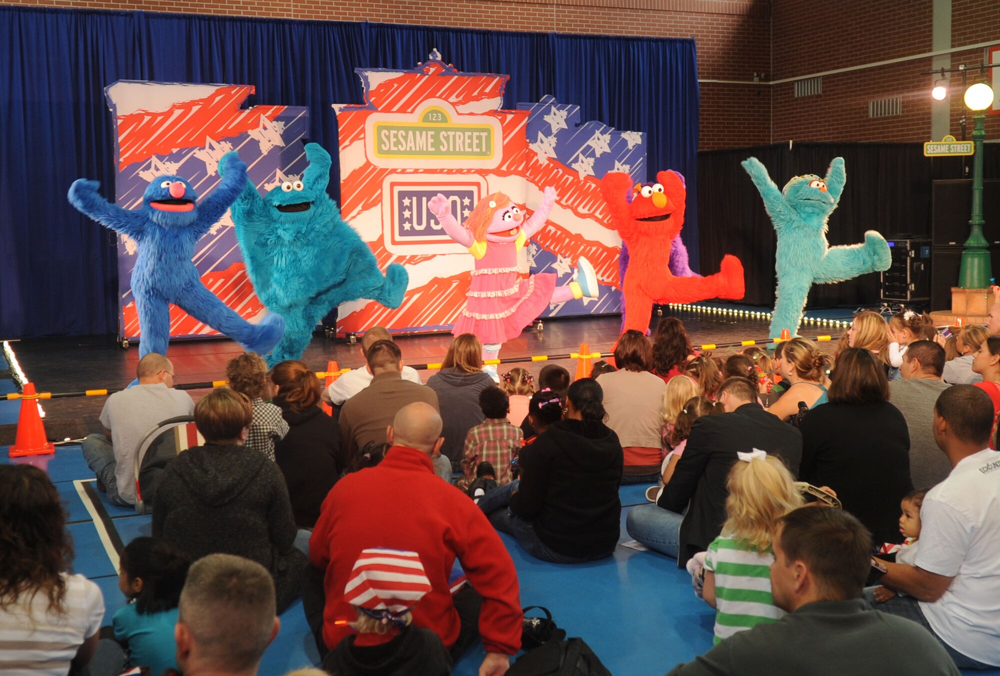 Families throughout the Kaiserslautern Military Community are entertained during the Sesame Street/USO Experience for Military Families Tour, Ramstein Air Base, Germany, Aug. 27, 2011. The 25-minute high-energy show follows a new character, Katie, as she opens up about her fears and excitement of moving to a new base. With the help of Elmo and other Sesame pals, Katie finds ways to deal with change and gets ideas on how to make new friends while keeping in touch with her old ones. (U.S. Air Force photo by Senior Airman Brittany Perry)