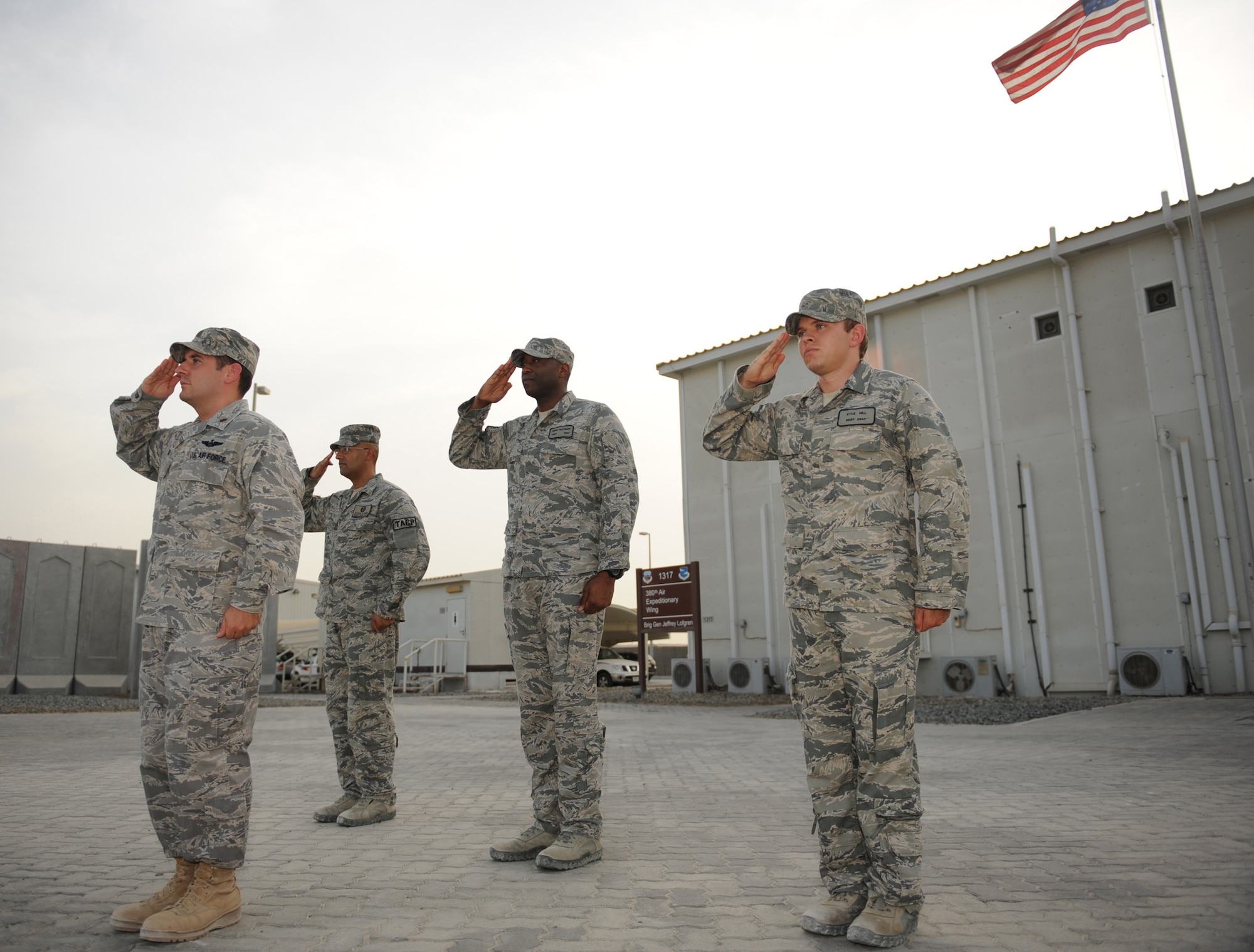 Three Tactical Air Control Party members and their air liaison officer pause to pay respect to their fallen brothers at a ceremony Aug. 25, 2011, at the 380th Air Expeditionary Wing in Southwest Asia. Their ceremony mirrored the TACP Memorial Ceremony held annually at Hurlburt Field, Fla. The Airmen rendered a salute and a observed a moment of silence for Staff Sgt. Jacob Frazier, Senior Airman Bradley Smith, Airman 1st Class Raymond Losano and all others who have given their lives in the defense of our nation. TACPs deployed worldwide align their individual ceremonies with the memorial in Florida to create a unified acknowledgement of those who have made the ultimate sacrifice. The TACP mission is to advise Army combat commanders on the use of Air Force air power. When necessary, they direct Air Force fighters and bombers in the employment of munitions within close proximity of friendly forces to neutralize enemy attacks. Pictured: Maj. Steven Wald, air liaison office, air support operations center director, Master Sgt. Victor Pena, TACP andsenior air director, Tech. Sgt. Jerry Pleasant, TACP andfighter duty technician, Staff Sgt. Kyle Hill, TACP and fighter duty technician. (U.S. Air Force photo/Master Sgt. Chance Babin).  