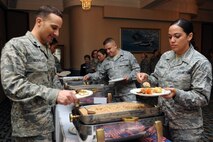 KUNSAN AIR BASE, Republic of Korea -- Airmen attending the Women’s Equality Day luncheon get food from the buffet line here Aug. 26. The date was selected to commemorate the 1920 passage of the 19th Amendment to the Constitution, granting women the right to vote. (U.S. Air Force photo/Senior Airman Brittany Y. Bateman) 