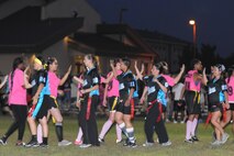 KUNSAN AIR BASE, Republic of Korea -- Airmen high five each other after a powder puff football game here Aug. 26. The game was one of the events held to celebrate Women’s Equality Day. (U.S. Air Force photo/Senior Airman Brittany Y. Bateman)