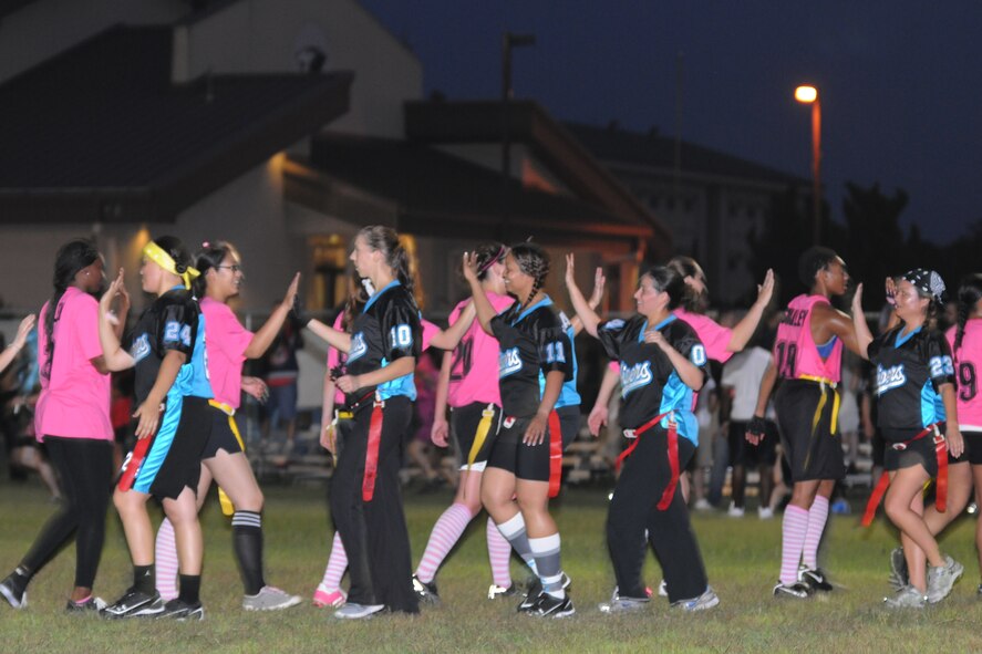 KUNSAN AIR BASE, Republic of Korea -- Airmen high five each other after a powder puff football game here Aug. 26. The game was one of the events held to celebrate Women’s Equality Day. (U.S. Air Force photo/Senior Airman Brittany Y. Bateman)