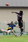 KUNSAN AIR BASE, Republic of Korea -- The 8th Medical Group plays against the 8th Maintenance Group in a Powder Puff football game here Aug. 26. The game was one of the events held to celebrate Women’s Equality Day. (U.S. Air Force photo/Senior Airman Brittany Y. Bateman)
