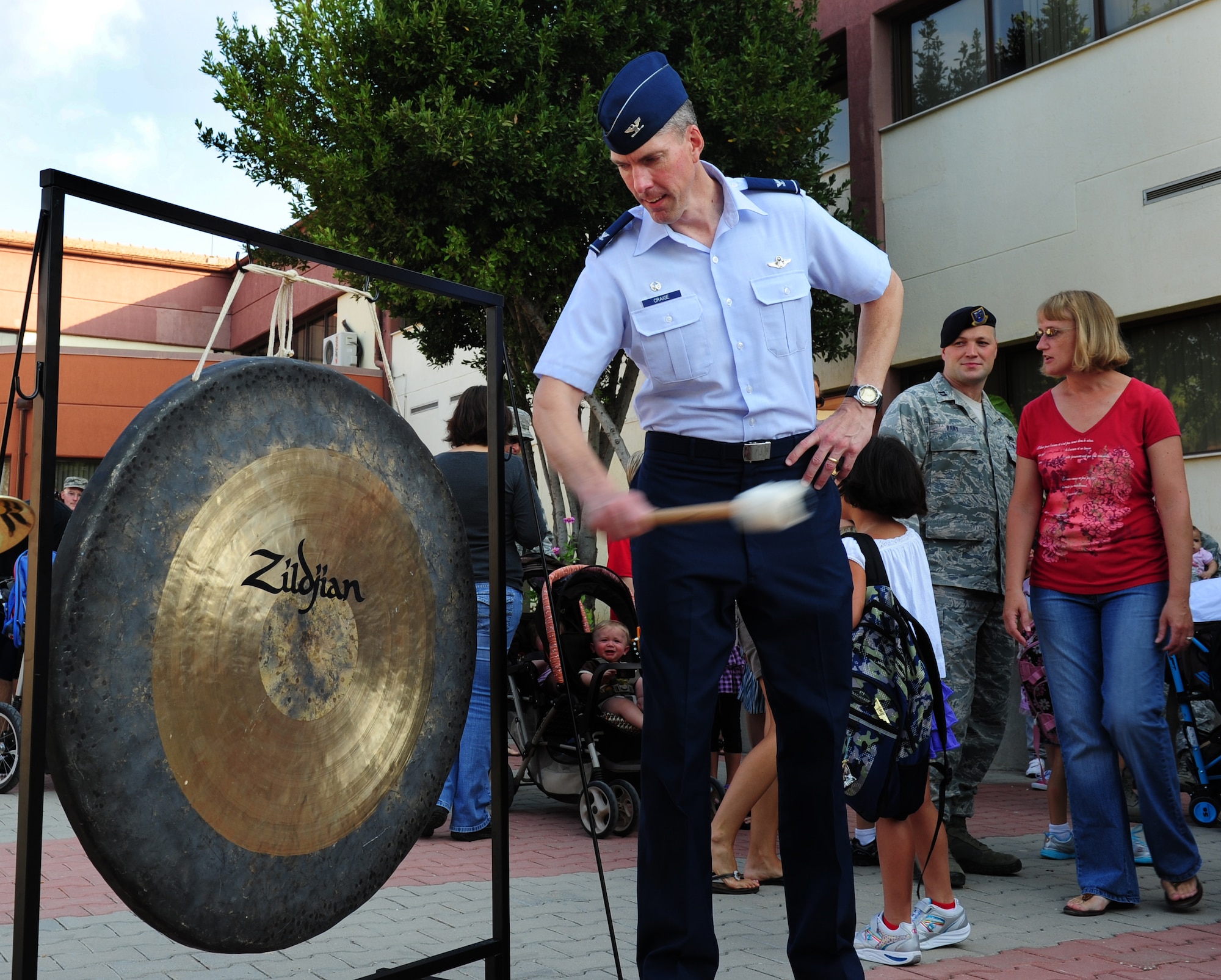 Col. Christopher Craige, 39th Air Base Wing commander, sounds a gong to signify the start of the school year Aug. 29, 2011, at Incirlik Air Base, Turkey. All grades began school today except kindergarten, which will begin the day after Labor Day. (U.S. Air Force photo by Senior Airman Anthony Sanchelli/Released)