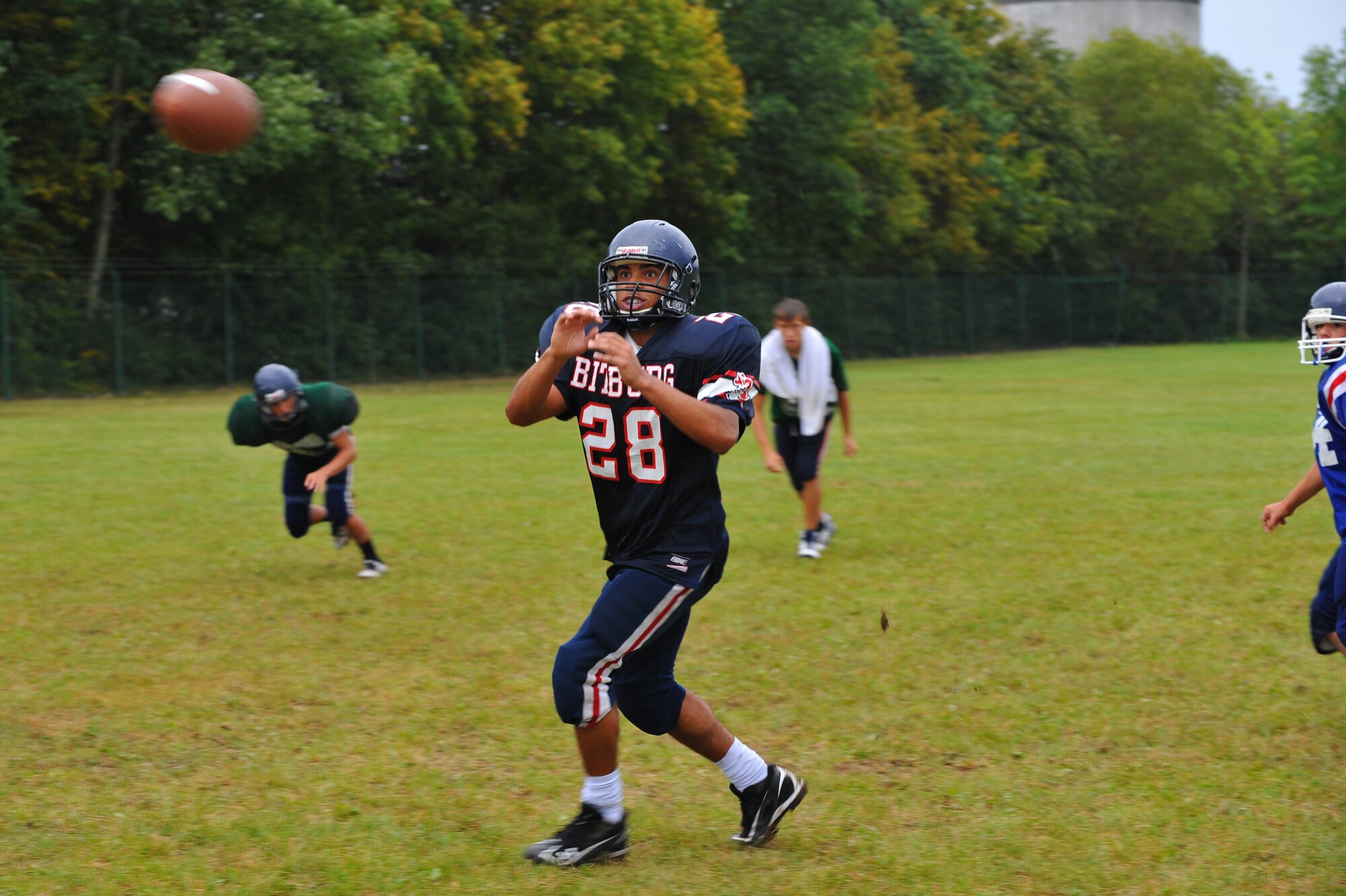 BITBURG ANNEX, Germany – Thomas Collins, Bitburg High School defensive back, prepares to catch a pass during pass receiver drills here Aug. 24. The football team practices five days each week. Practices normally consist of a warm-up, cardio, strengthening exercises, hitting drills, blocking drills and running drills. The season tentatively kicks off with an away game against Heidleberg on Sept. 3. (U.S Air Force photo/Airman 1st Class Dillon Davis)