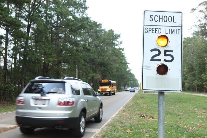 A speed limit sign on Stone St. aboard Marine Corps Base Camp Lejeune, flashes, warning drivers aboard the base to drive the posted limit especially in the school zones, Aug. 30. The N.C. Senate Bill 49 went into effect at the beginning of the school year and introduced a hefty monetary fine for violators, but since there are no monetary penalties aboard the base for violations, military police are doing what they can to enforce and educate the base on the new regulations.