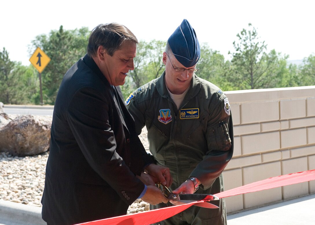 Col. Mark Weatherington, 28th Bomb Wing commander, and Al Dial, Mayor of Box Elder, S.D., cut the ribbon during a re-opening ceremony at Liberty Gate at Ellsworth Air Force Base, S.D., Aug. 25, 2011. The renovation of Liberty Gate was part of a three-year,$ 12.1 million military construction project that included work at all three of the base’s gates. (U.S. Air Force photo/Airman Alystria Maurer/Released)