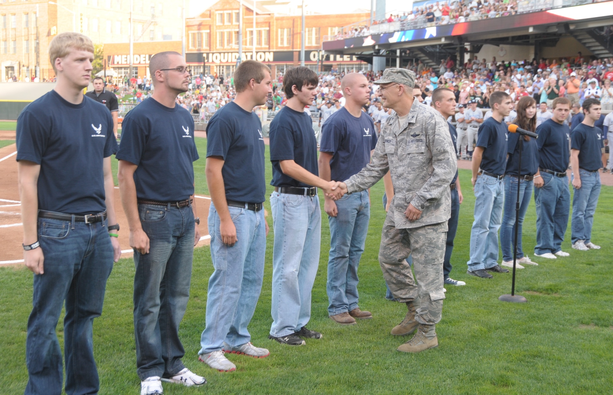 New Air Force recruits stand at attention after a swearing in ceremony by Brig. Gen. Arnold Bunch, Air Force Security Assistance Command commander on Saturday, Aug. 27.  The ceremony, held at the Dayton Dragon's “Hometown Heroes Celebration Night,” pays tribute to the local servicemen and women of Wright-Patterson Air Force Base and the Springfield Air National Guard. (U.S. Air Force photo/ Albert Bright)