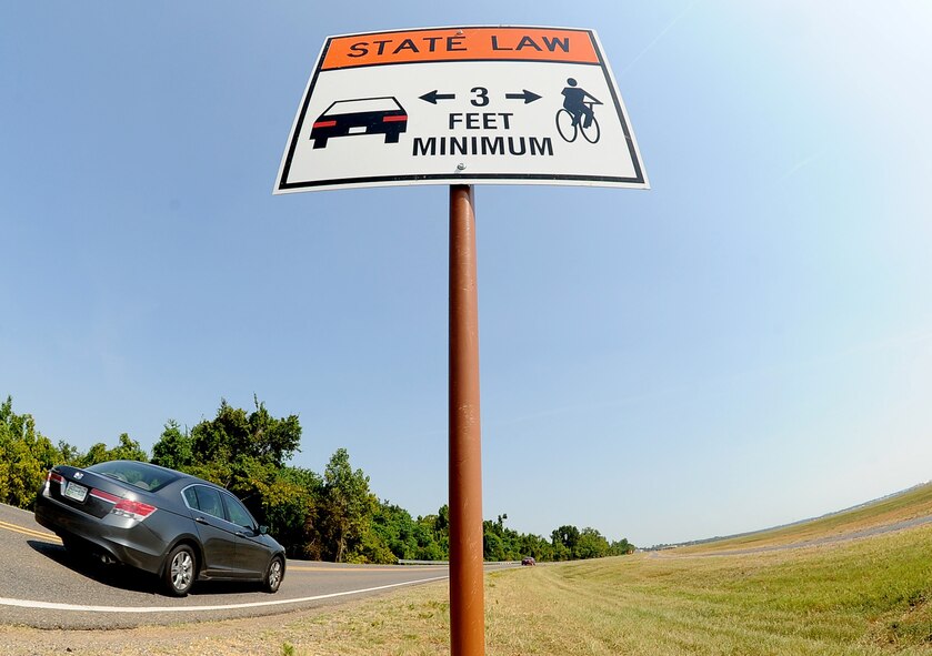 Vehicles pass a brand-new sign on the East side of Barksdale Air Force Base, La., Aug. 30. The sign clearly reminds both passing vehicles and bicycle riders to heed the distance between them for safety. (U.S. Air Force photo/Senior Airman Amber Ashcraft) (RELEASED)