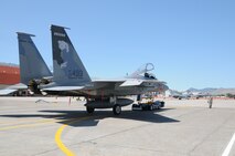 Senior Airman Andrew Petersen moves an F-15 Eagle with an electrical tug made by the Ore. based company Lektric  as Master Sgt. Jeff Johnson sits in the cockpit July 24, 2011 at Kingsley Field, Klamath Falls, Ore.  The 173rd Fighter Wing is testing out the newly designed electrical tug that is much more maneuverable and efficient compared to the traditional diesel tug.  All of the Airmen are from the 173rd Fighter Wing Inspection Element.   (U.S. Air Force Photo by Tech. Sgt. Jennifer Shirar) RELEASED