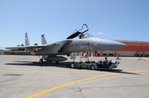 Senior Airman Andrew Petersen moves an F-15 Eagle with an electrical tug made by the Ore. based company Lektric  as Master Sgt. Jeff Johnson sits in the cockpit July 24, 2011 at Kingsley Field, Klamath Falls, Ore.  The 173rd Fighter Wing is testing out the newly designed electrical tug that is much more maneuverable and efficient compared to the traditional diesel tug.  All of the Airmen are from the 173rd Fighter Wing Inspection Element.   (U.S. Air Force Photo by Tech. Sgt. Jennifer Shirar) RELEASED