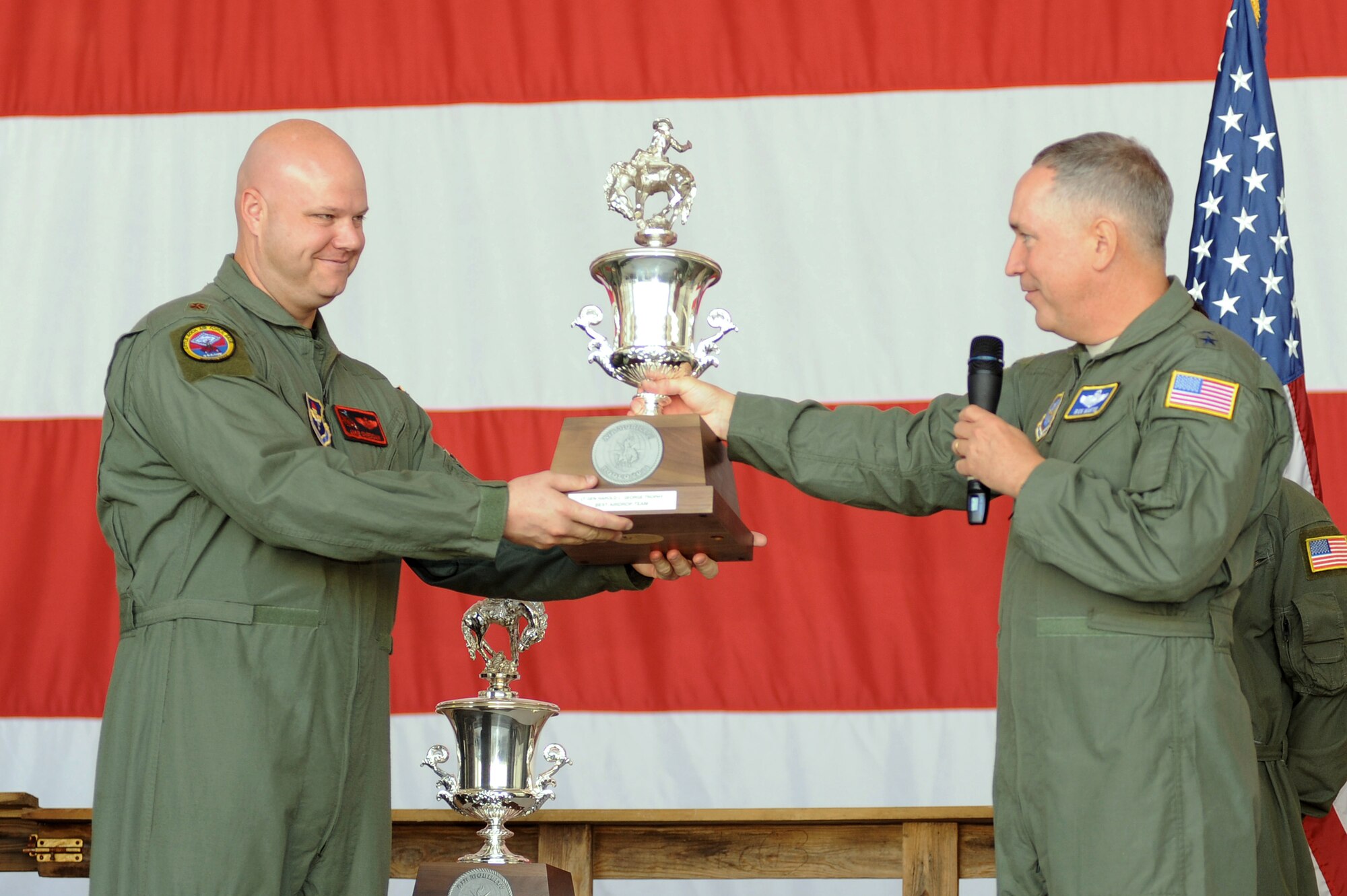 Maj. Gen. Frederick Martin (center), Director of Operations, Headquarters Air Mobility Command, Scott Air Force Base, presents the Lt. Gen. Harold L. George Trophy for Best Airdrop Team to Maj. Jacob Sheddan, 62nd Airlift Squadron Assistant director of operations, Aug. 29, 2011 at Little Rock Air Force Base, Ark. A programming error in the Air Mobility RODEO 2011 scoring system resulted in a change to several major awards including the Best Air Mobility Wing and Best Airdrop Wing, both awarded to the 314th Airlift Wing. (U.S. Air Force photo by Tech. Sgt. Chad Chisholm)