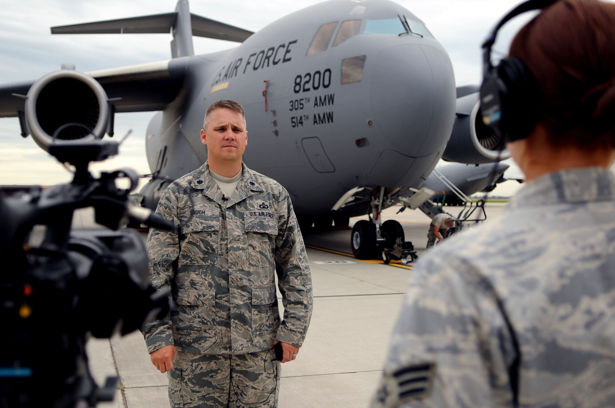 Lt. Col. Bradley Baugh (left), 319th Operations Support Squadron commander, is interviewed by Senior Airman Priscilla Christensen, 319th Public Affairs broadcaster, about Grand Forks Air Force Base’s support in housing three C-17 Globemaster IIIs and eight KC-10 Extenders during Hurricane Irene evacuation tp GFAFB Aug 27. The mission helped protect these $200 million assetst by opening up the flight line to house the aircraft. (U.S. Air Force photo by Senior Airman Amanda N. Stencil)