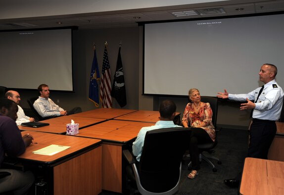 Maj. Eric Levesque,Air Reserve Personnel Center selection board division chief, provides a mission brief to the Congressional Staff Members specializing in Reserve affairs Aug. 26, 2011,on Buckley Air Force Base, Colo. This was the staffers first-ever visit to ARPC’s headquarters. (U.S. Air Force photo/Tech. Sgt. Rob Hazelett)