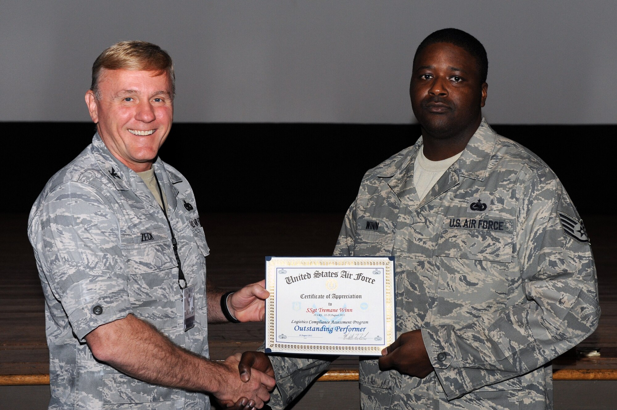 Col. William “Zack” Zeck, Air Mobility Command A4T division chief, presents an award to Staff Sgt. Tremane Winn, a 19th Logistics Readiness Squadron NCO in charge of inbound Aug. 29, 2011, at Little Rock Air Force Base, Ark.  Winn was one of many Airmen recognized for outstanding performance during the Logistics Compliance Assessment Program. (U.S. Air Force photo by Airman 1st Class Rusty Frank) 