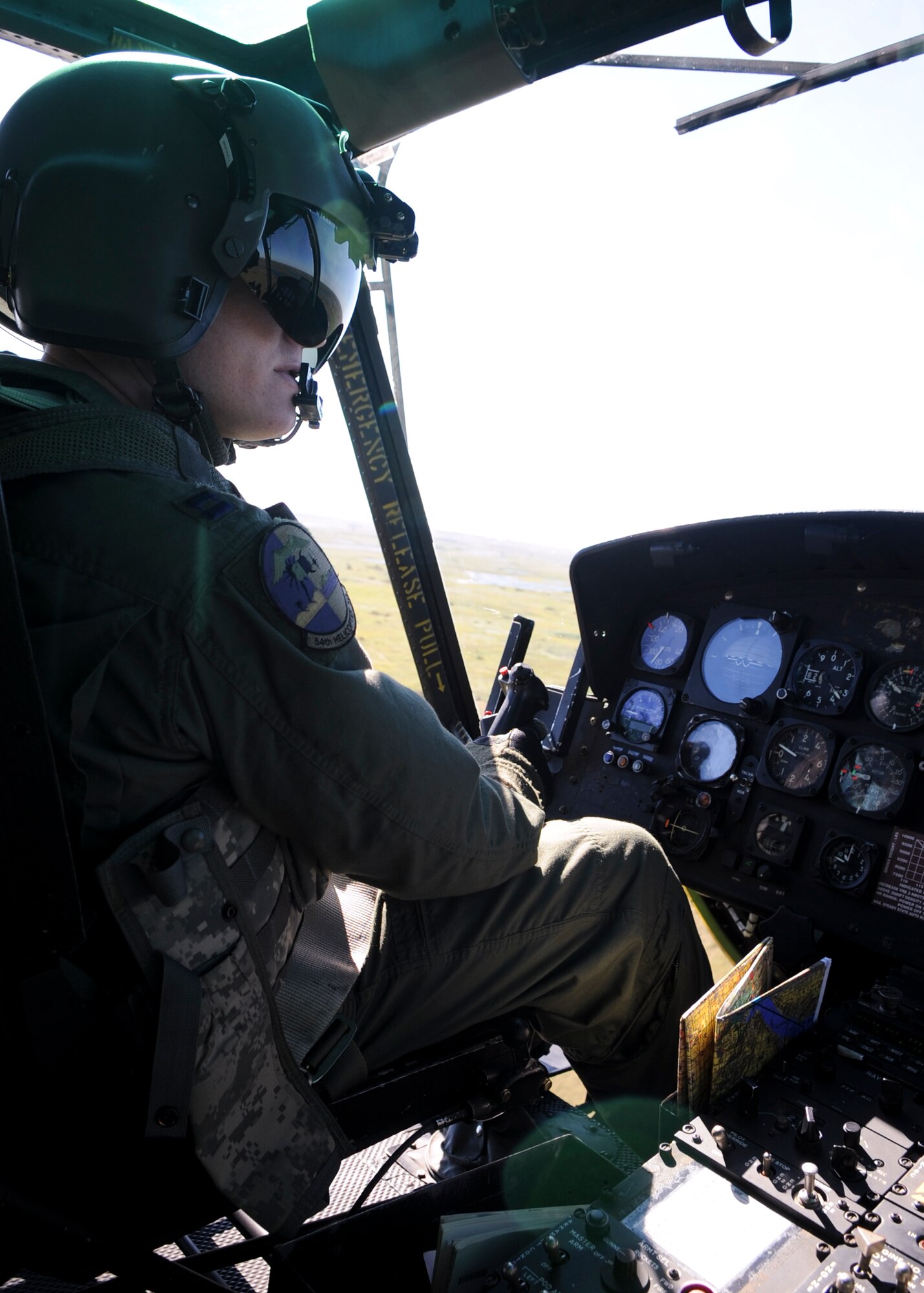 MINOT, N.D. -- Capt. Michael Dommer, 54th Helicopter Squadron UH-1N helicopter pilot, flies over Minot Aug. 24, as part of a surveying mission of Federal Emergency Management Agency trailers. Members of the 54th HS also assisted in surveying local damage caused by the recent flooding situation in Minot which prompted the displacement of thousands of Minot residents, including hundreds of Air Force Global Strike Command Airmen. (U.S. Air Force Photo/Senior Airman Ashley N. Avecilla)