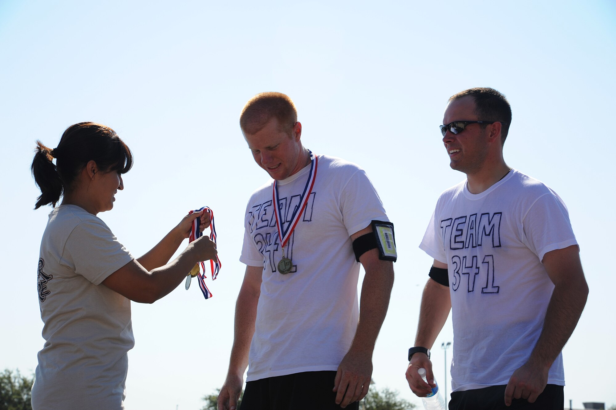 GOODFELLOW AIR FORCE BASE, Texas -- Team 341 receives their first place medals after winning the Remarkable Race, here, Aug. 27. Team 341 completed each challenge flawlessly giving them 1st place by a huge margin. (U.S. Air Force photo/ Airman 1st Class Michael Smith)