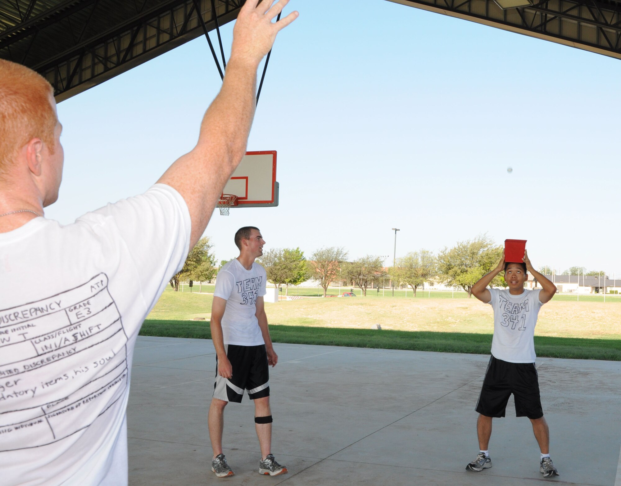 GOODFELLOW AIR FORCE BASE, Texas—Members of Team 341 attempt to toss a golf ball into a bucket 15 feet away during the Remarkable Race, Aug. 27 here. Nine four-person teams participated in the 2.5 mile race. Team 341 took first place. (U.S. Air Force photo/Airman 1st Class Jessica Keith) 