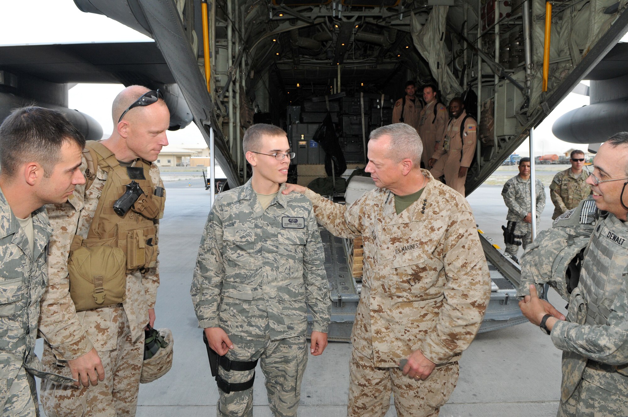 Marine Corps Gen. John R. Allen, commander of NATO and International Security Assistance Force troops in Afghanistan, promoted Airman 1st Class Gabriel J. Poling, a cyber transport systems Airman deployed from 325th Communications Squadron, Tyndall Air Force Base, Fla., Aug. 25, to the rank of senior airman. The impromptu promotion ceremony took place on the flightline of Kabul International Airport following a battlefield circulation of Regional Command-Southwest. Airman Poling is part of COMISAF's joint communications team who help keep General Allen connected to military and civilian leaders about all things Afghanistan. ISAF is a key component of the international community's engagement in Afghanistan, assisting Afghan authorities in providing security and stability while creating the conditions for reconstruction development. (Photo by Master Sgt. Michael O'Connor) 


